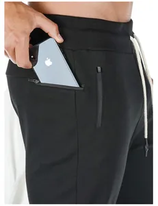 Close-up detail of black men's sports sweatpants featuring a secure side zipper pocket