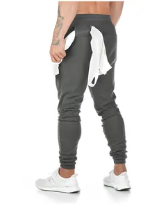 Close-up back view of men's charcoal grey cotton joggers showing fit and ankle cuff detail