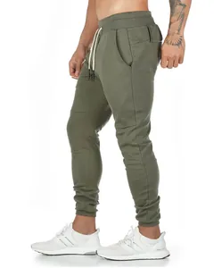 Side profile detail of olive green slim-fit cotton joggers for men's fitness and running