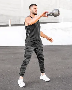 Men's dark camouflage sports joggers shown in action during a gym workout outdoors