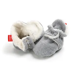 Detailed view of warm grey fleece baby booties with soft white faux fur lining