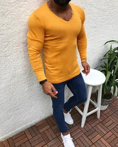 Macro view of slim fit mustard yellow long sleeve knit sweater for men outdoors