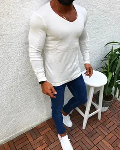 Casual men's slim fit white V-neck long sleeve knit sweater styled with blue jeans