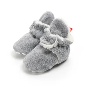 Cozy grey fleece baby booties with soft plush lining and adjustable strap detail