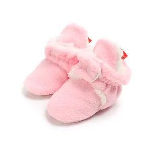 Cozy pink fleece winter baby booties with soft white trim and warm lining for infants.