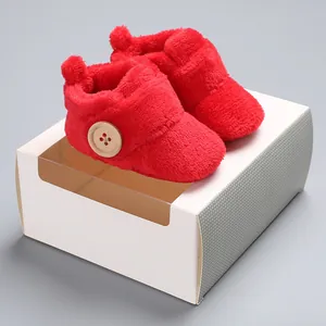 Ultra-soft red plush baby walking shoes with wooden button detail on white gift box