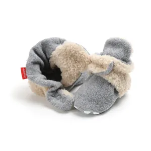 Macro view of gray fleece baby booties with soft cream faux fur lining
