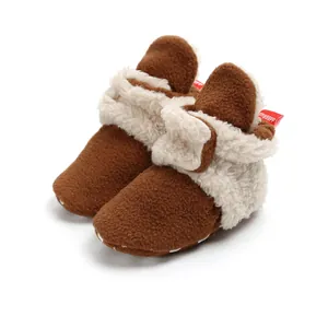 Close-up of cozy brown and cream baby winter fleece boots with soft soles and linings