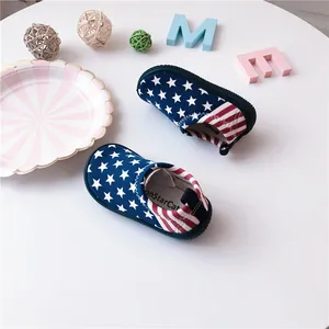 Close-up view of children's slip-on canvas shoes featuring a stars and stripes design
