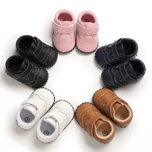 Collection of stylish multi-colored baby walking shoes featuring brogue perforated details.