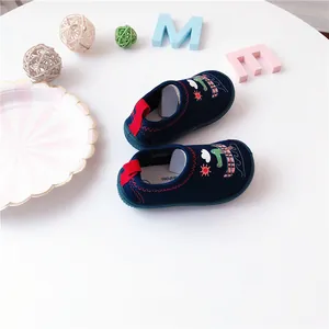 Close-up of toddler slip-on shoes with cute cartoon dinosaur and boat pattern