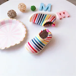 Close-up of rainbow striped baby canvas slip-on shoes for toddler walking