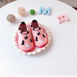 Detail view of pink toddler slip-on shoes with cute cat pattern and star prints