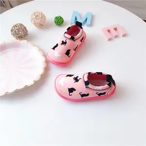 Detailed top-down view of pink toddler slip-on shoes featuring cute cat and star patterns