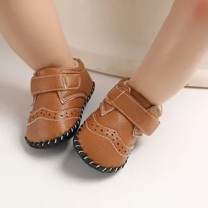 Close-up of brown leather baby walking shoes with exquisite white stitching detail