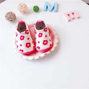 Close-up of pink floral toddler walking shoes with elastic canvas slip-on design