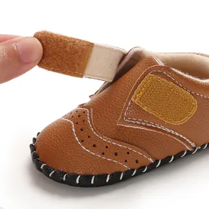 Detailed view of brown baby walker shoe with adjustable hook-and-loop strap.