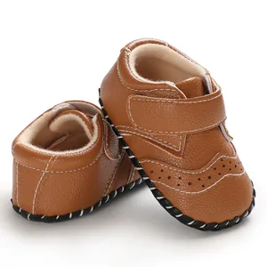 Close-up detail of brown baby walking shoes with anti-slip rubber soles and velcro straps