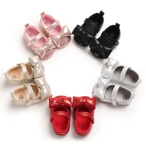 Detailed view of various colorful soft-sole infant princess shoes with bow tie decorations