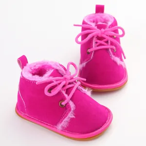 Nahaufnahme von pinkfarbenen Baby-Winterstiefeln mit weichem Kunstfellfutter und Schnürung
