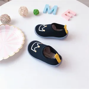 Detailed view of toddler black elastic canvas slip-on shoes with crown embroidery