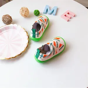 Close-up detail of children's white dinosaur print elastic canvas toddler shoes
