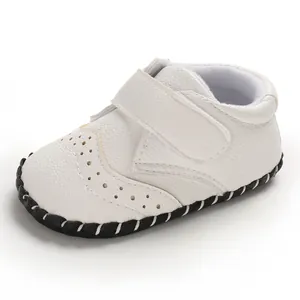 Detailed view of white faux leather baby walker shoe with elegant perforated design