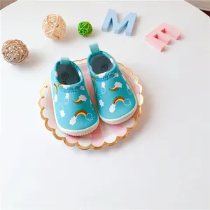 Close-up of baby walking shoes with rainbow print and elastic canvas