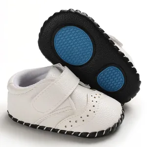 Close-up of white baby walking shoes with anti-slip rubber sole and velcro strap