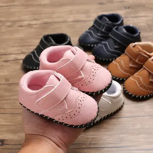 Detail shot of pink baby walking shoes with anti-slip rubber soles and Velcro straps.