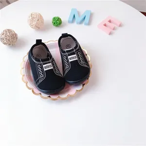 Detail view of black canvas baby slip-on walking shoes for toddlers with elastic band
