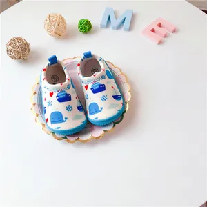 Detailed view of baby slip-on canvas walking shoes featuring cute blue whale and nautical print