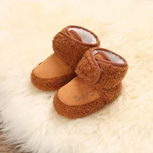 Close-up of warm brown baby snow boots with fleece lining and Baby embroidery