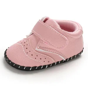 Close-up view of pink baby walking shoes with perforated design and non-slip sole