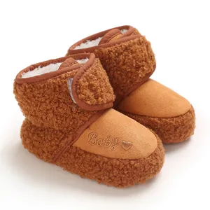 Macro view of cozy brown baby winter walking boots with soft fleece and embroidery.