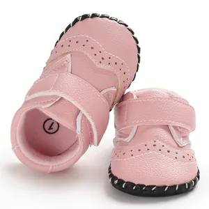 Detailed view of pink baby walker shoes with perforated patterns and rubber soles