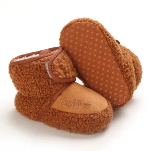 Detailed view of warm brown plush baby snow boots featuring a non-slip dotted sole