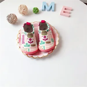 Close-up of children's floral print slip-on walking shoes with cute pink rubber soles