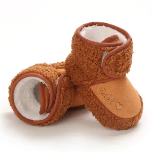 Close-up of brown baby winter boots with warm sherpa lining and 'Baby' embroidery.