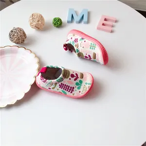 Overhead detail view of toddler canvas walking shoes featuring colorful floral prints