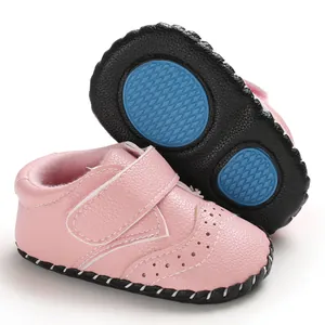Detailed view of pink baby walking shoes with anti-slip rubber soles and hand-stitched finish.