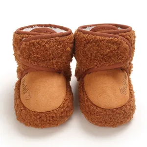 Front view of brown fleece baby winter boots with soft soles and heart embroidery