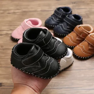 Detail view of assorted soft-sole baby walker shoes with hand-stitched brogue accents.