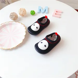 Close-up showing the stretch canvas material and cartoon face of toddler shoes