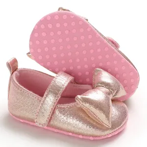 Detail view of rose gold baby girl princess shoes with soft non-slip sole and bow