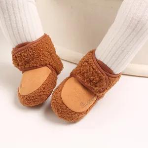 Warm and cozy brown plush baby winter snow boots with soft sole for infant walking support