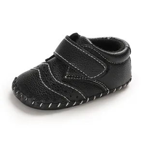 Detailed view of black baby walker shoe with white contrast stitching and velcro strap
