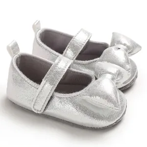 Close-up detail showing the silver glitter finish and large bow on baby princess shoes