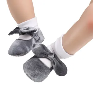 Elegant grey velvet baby girl pre-walker shoes featuring a large bow and soft sole