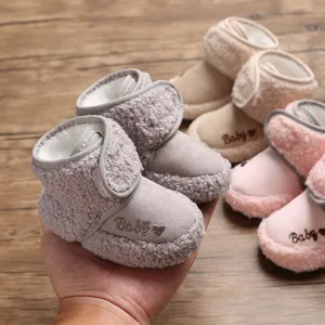 Close-up of cozy fleece-lined baby snow boots with embroidered heart detail.
